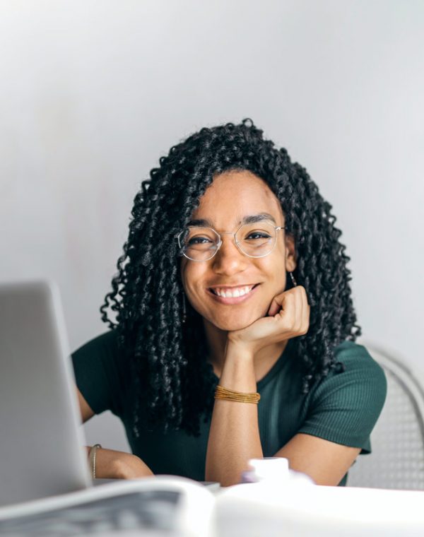 happy-ethnic-woman-sitting-at-table-with-laptop-3769021.jpg